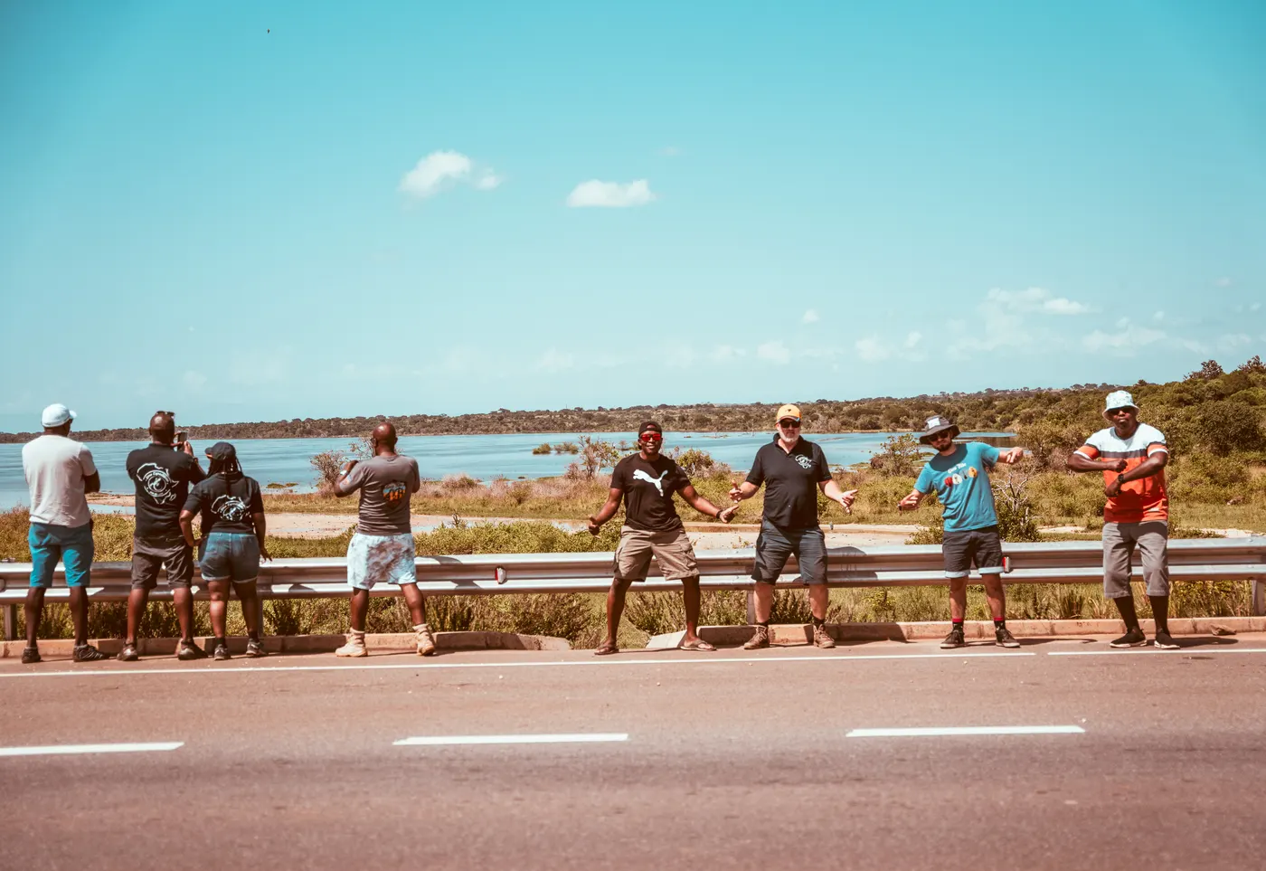 Group of people taking a break beside a roadside viewpoint