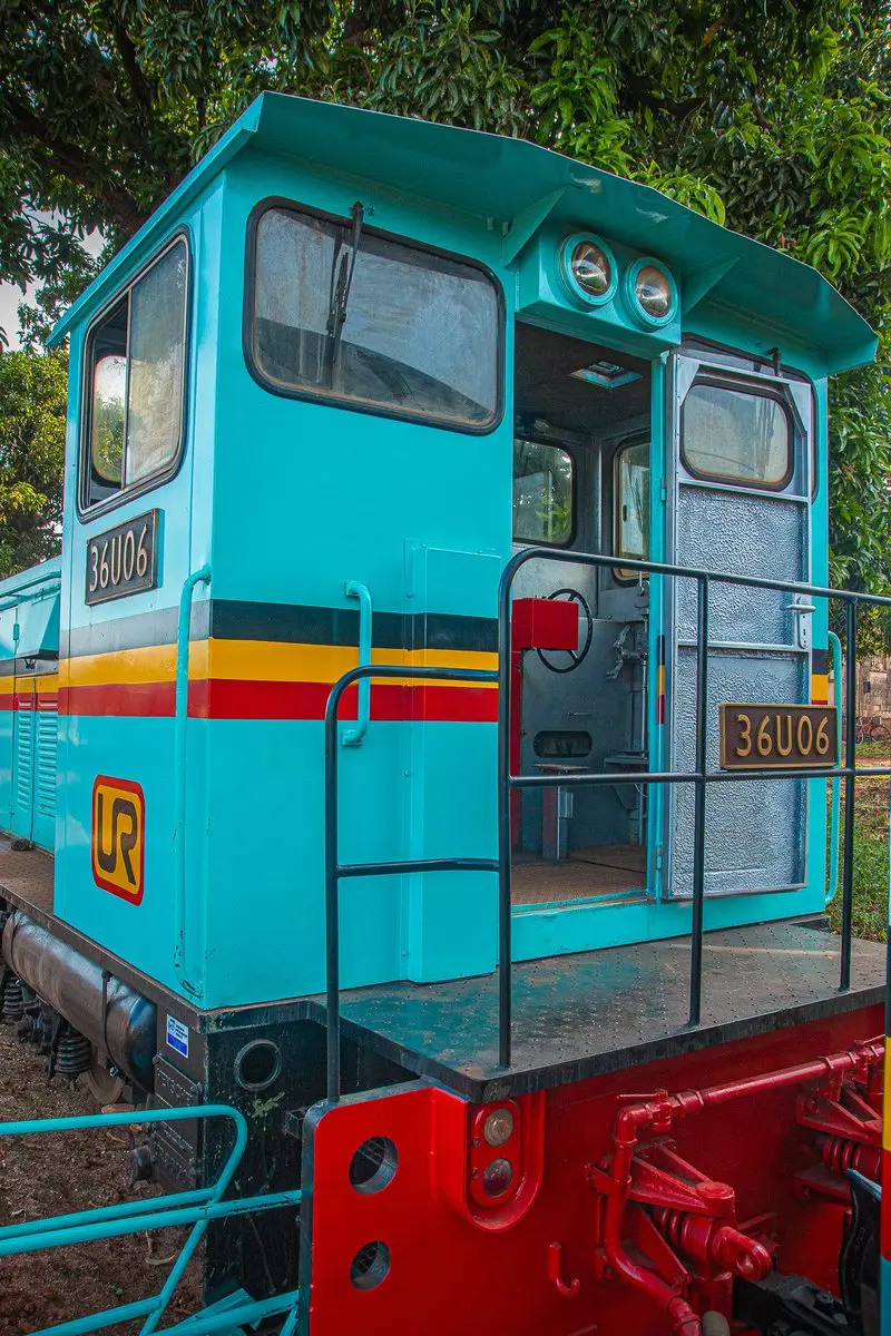 Turquoise railway locomotive on display in Jinja