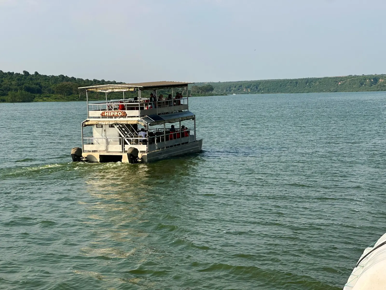 Passenger boat moving across a broad stretch of water